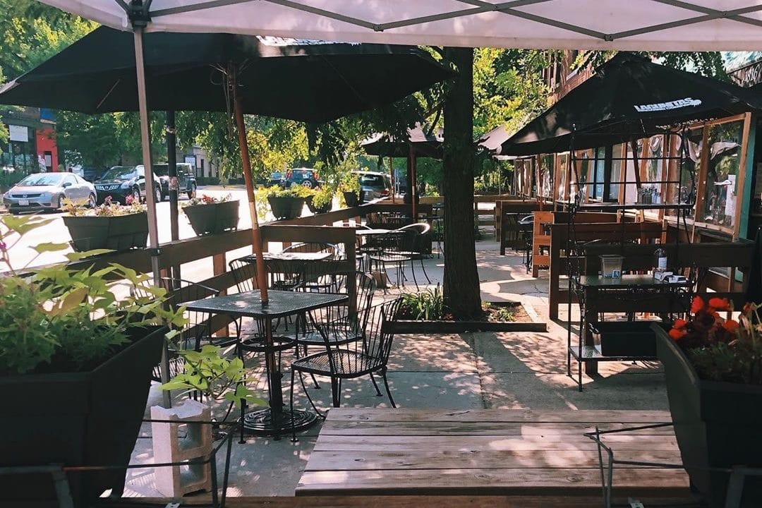 A picture of River Valley Farmer's Table's serene, shady patio on Wilson Ave