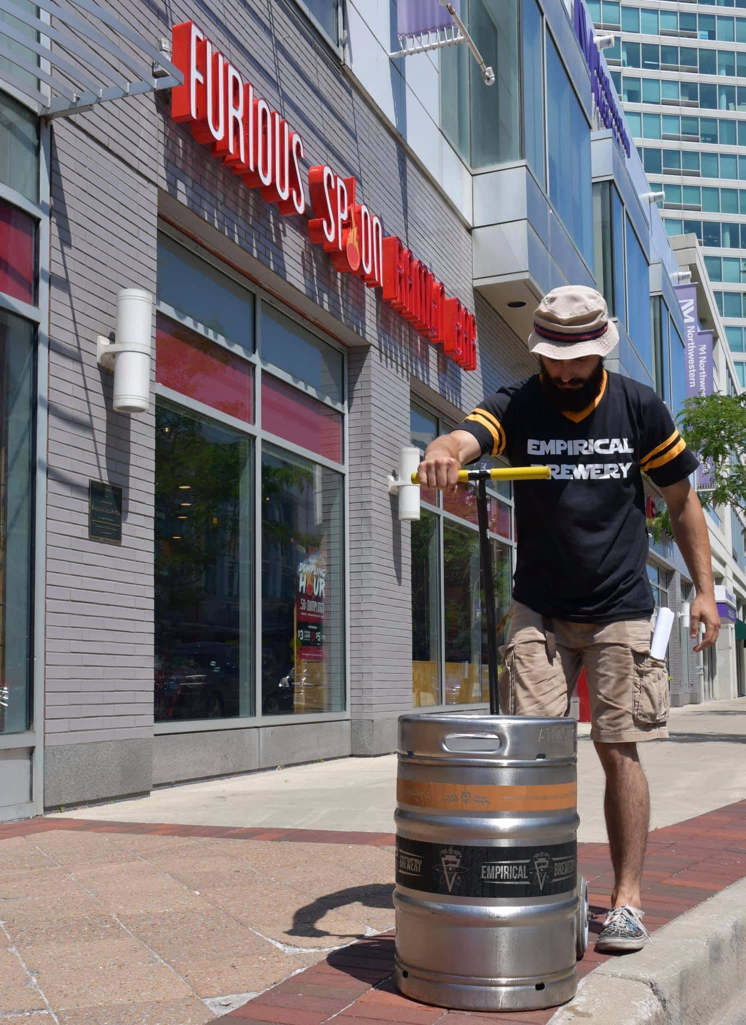 A photo of an Empirical Sales Representative dropping off a keg at a local restaurant