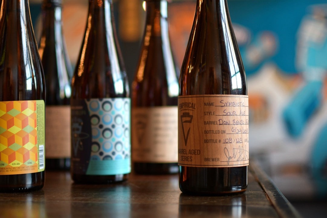 A photo of a group of bottles of barrel aged beers from Empirical Brewery