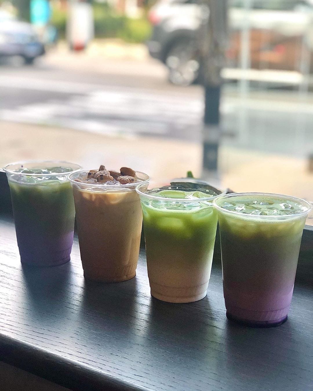 A picture of several colorful lattes