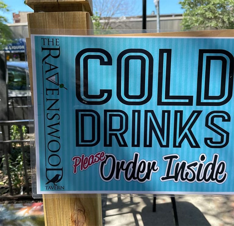 A picture advising customers to order cold drinks inside, even if they're outside on this dog friendly patio in Ravenswood