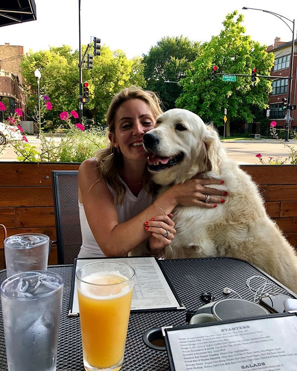 A dog and owner enjoy the patio at Wolcott Tap in Ravenswood