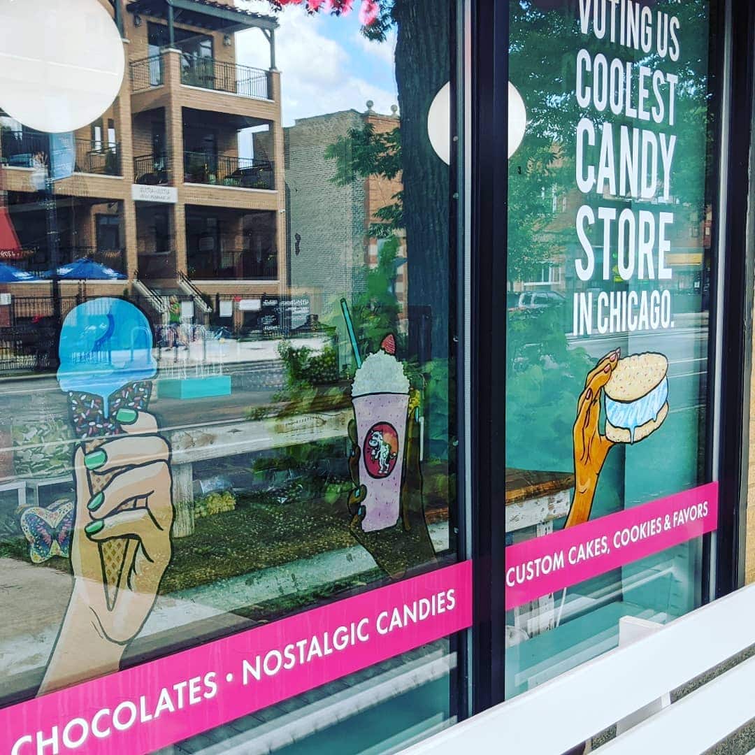 Picture of a Amy's Candy Bar's storefront, a blue ice cream cone painted on the glass