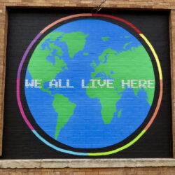 We All Live Here mural in Ravenswood by artist Richard Alapack