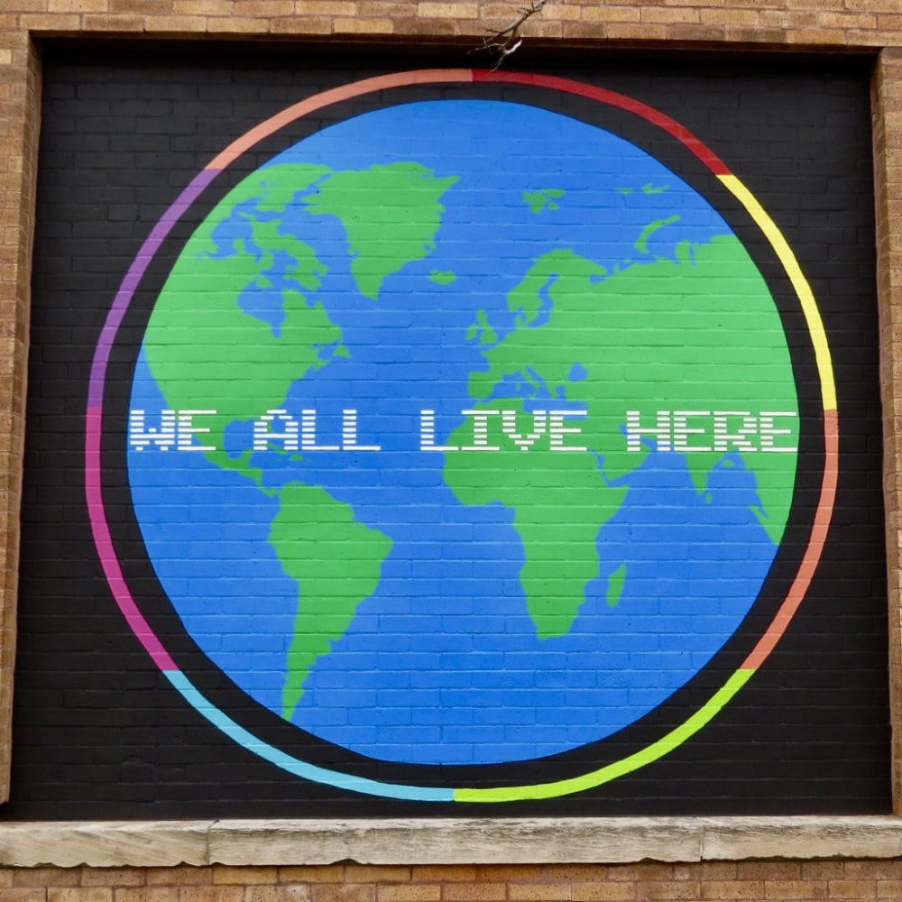 We All Live Here mural in Ravenswood by artist Richard Alapack