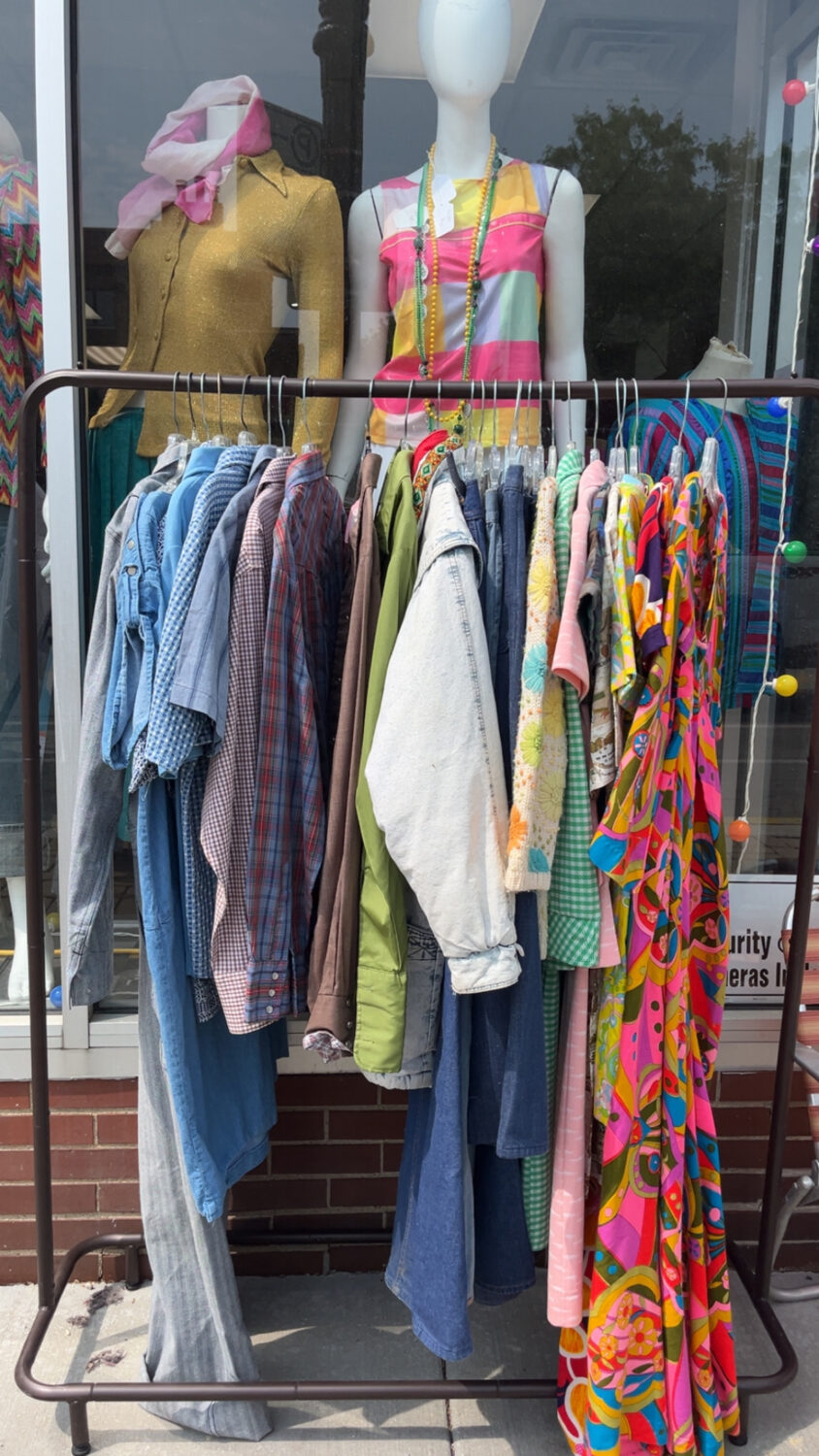 A rack of clothes at Outskirts Vintage for the Sidewalk Sale 2025 