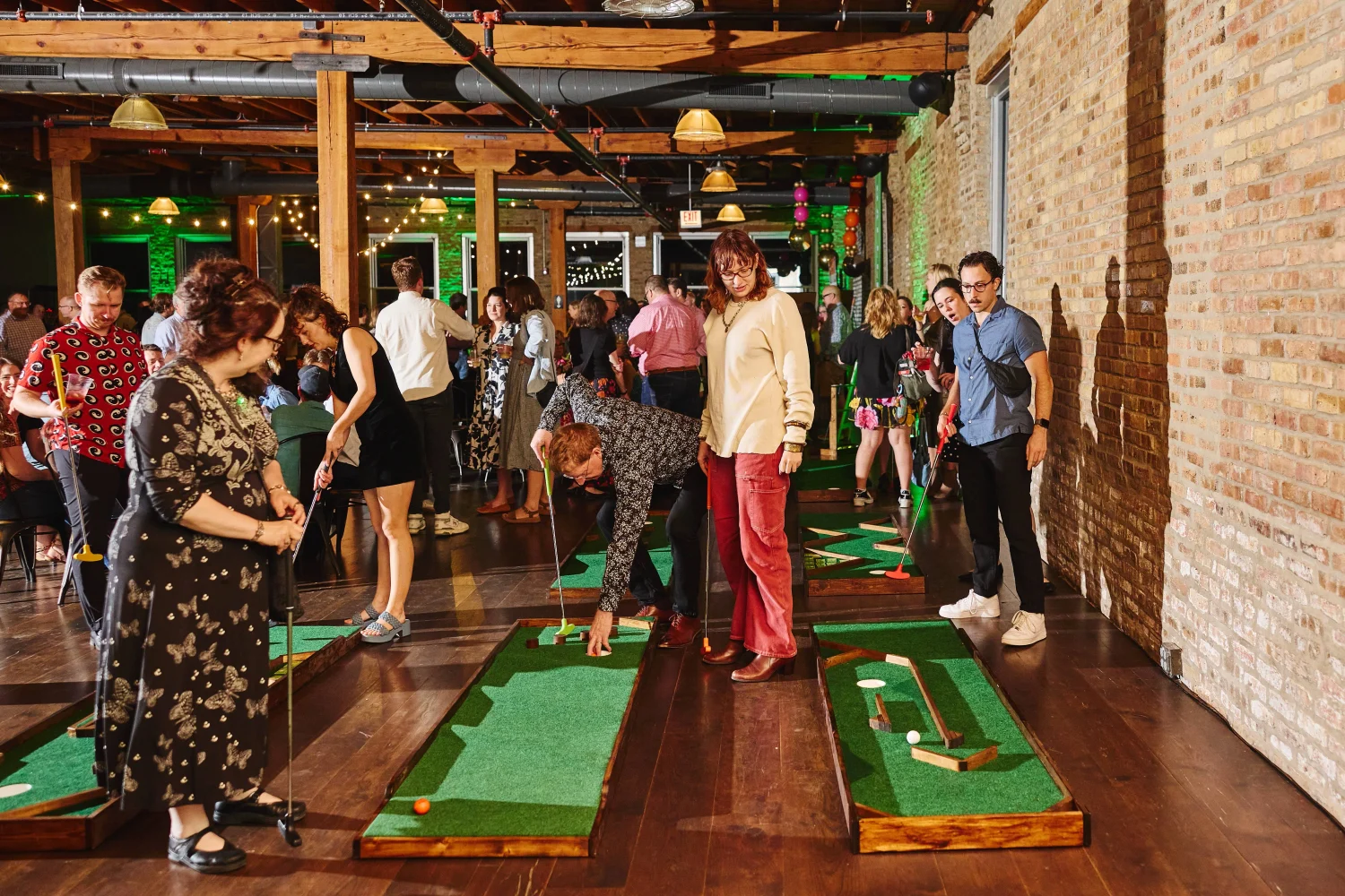 Attendees of Common Pantry's I Am Your Neighbor party enjoy mini golf stations 