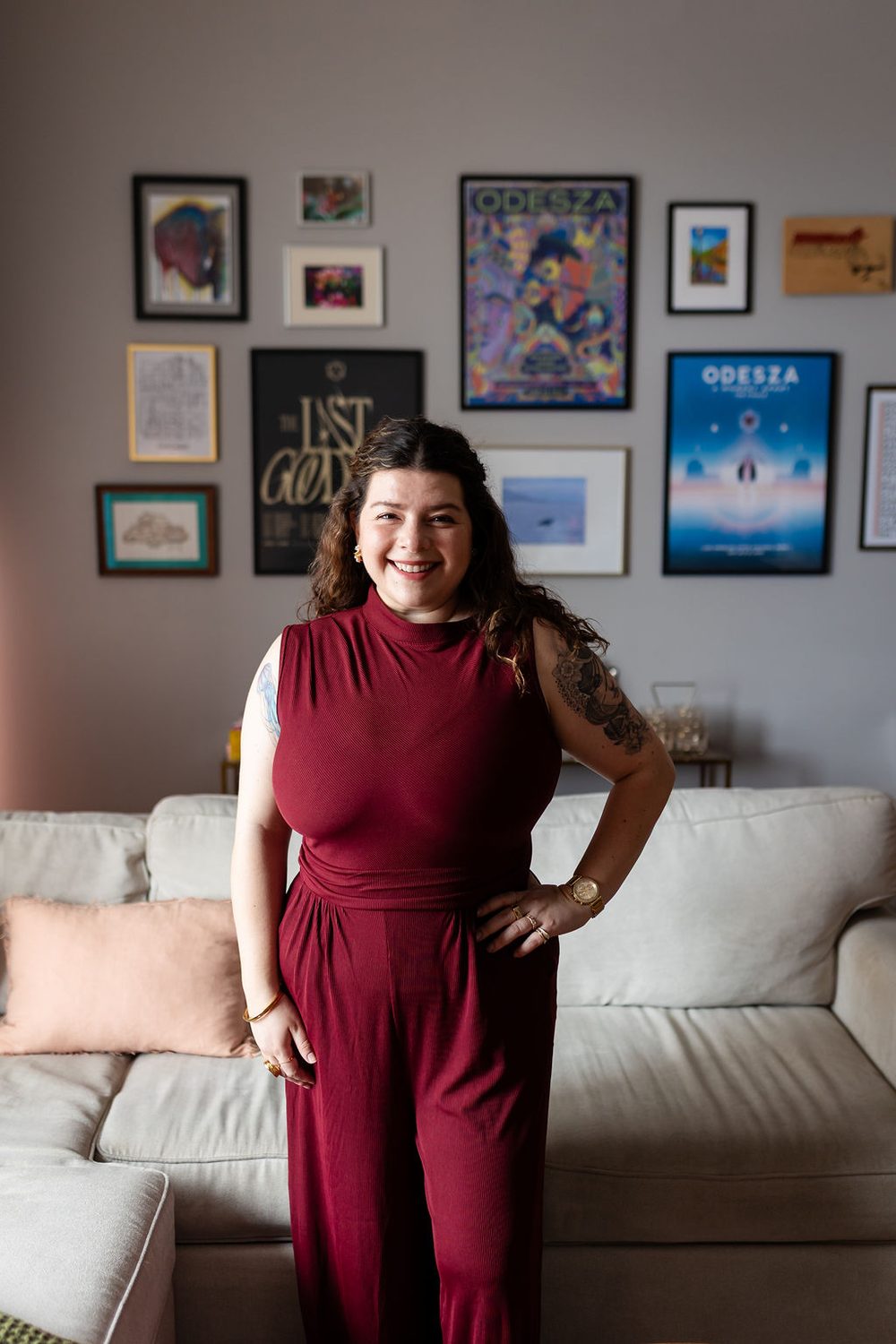 Lindsay Marcus stands in a red jumpsuit, posing for the camera