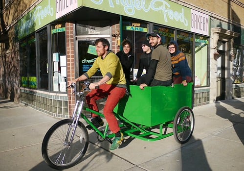 Green Machine's owner Ezra totes around a small group of people in a cargo bike 