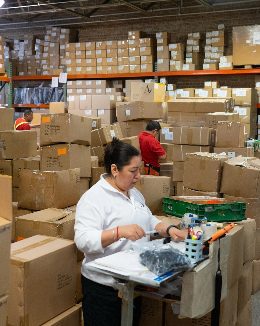 A woman checks boxes on the floor at Accurate Products
